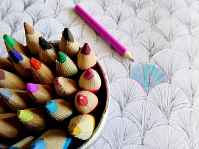 Colored pencils and adult coloring book smaller